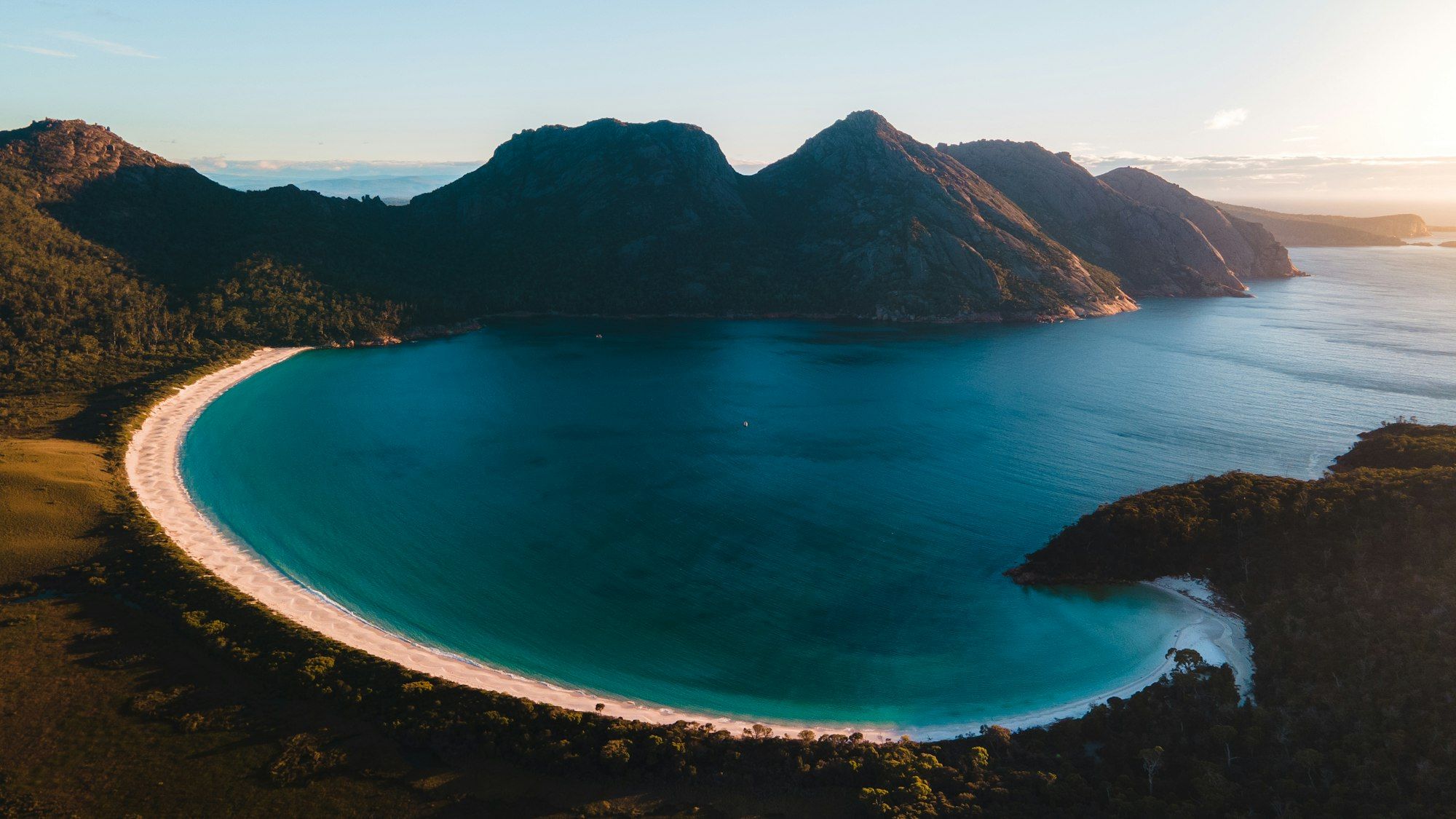 Aerial view over the curved bay and granite peaks of Wineglass Bay, Freycinet, Tasmania